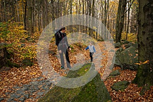 Mum and child are walking along the mountain hiking trail. Family spending time