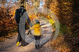 Mum and child are walking along the mountain hiking trail. Family spending time