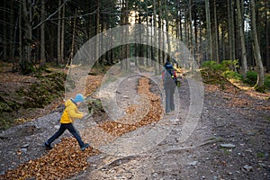 Mum and child are walking along the mountain hiking trail. Family spending time