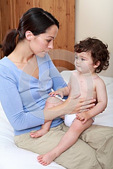 Mum comforting sick baby