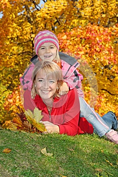 Mum with a daughter in autumn park