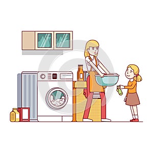Mum and daughter doing housework in laundry room