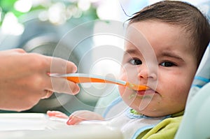 Mum feeds the small child