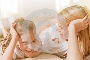 Mum and her cute daughter child girl are playing, smiling and hugging. Happy mother& x27;s day.