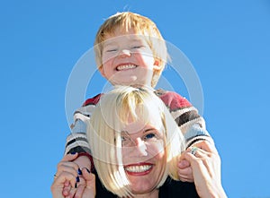 Mum holding son on shoulders