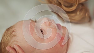 Mum kisses the baby and leaves traces of lipstick