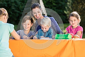 Mum painting pictures with their children and during lunch break