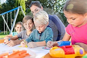 Mum painting pictures with their children and during lunch break