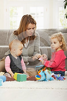 Mum playing with two daughters photo