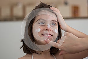 Mother Applying Sunscreen photo