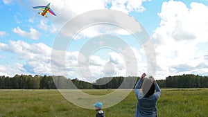 Mum and son flying kite outdoor