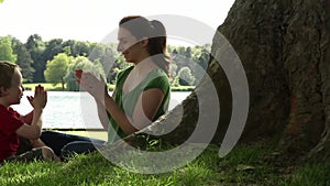 Mum and son playing under a tree