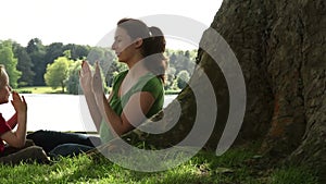 Mum and son playing under a tree