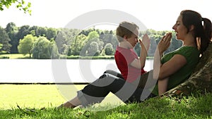 Mum and son playing under a tree