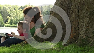 Mum and son playing under a tree