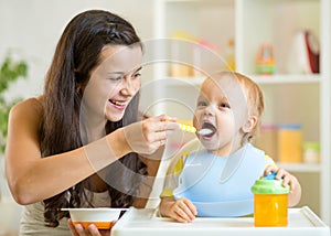 Mum spoon feeding child son