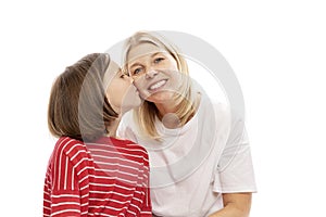 Mum with a teenager daughter laughing and hugging, isolated on white background. Tenderness and love