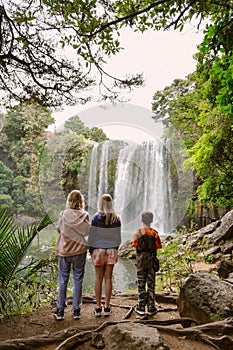 Mum and Two children looking at Waterfall in New Zealand.