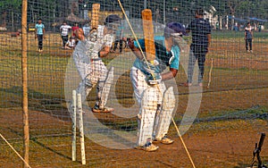 Unidentified boys practicing batting to improve cricketing skills at Mumbai ground