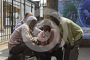 Mumbai, Maharashtra, India- 05-10-2019. Men of different religion checking cricket score in a mobile phone. Unity in diversity.