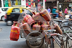 Mumbai, Marhashtra, India / 15 november, 2018: orange gas tanked transported by bike