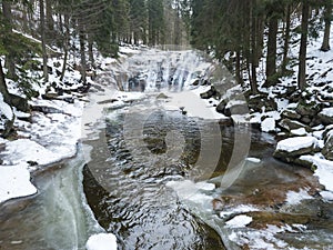 Mumlavsky vodopad, waterfall on Mumlava river stream in Krkonose National Park, Czech Republic in winter snow covered