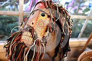 Mummer mask on felt boot