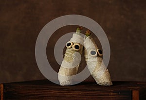 Mummies made of banana and white bandage with eyes on a wooden box