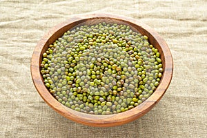 Mung beans or mash peas in wooden bowl