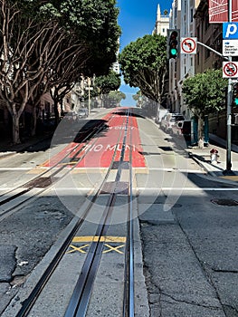 Muni red road surface painted sign on a street of San Francisco