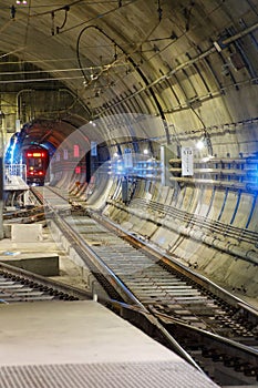 A muni train is going into a tunnel.