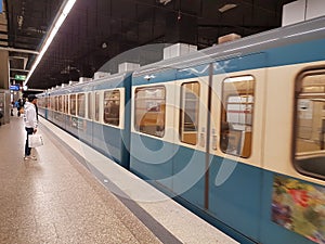 MUNICH, GERMANY - APRIL 2, 2020: A photo of a old subway train arriving to a deserted  Main Trainstation station in Munich