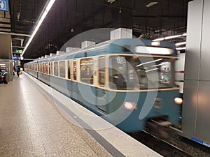 MUNICH, GERMANY - APRIL 2, 2020: A photo of a old subway train arriving to a deserted  Main Trainstation station in Munich