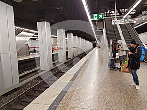 A photo of a old subway train arriving to a deserted  Main Trainstation station in Munich, Germany, in the time of the Corona