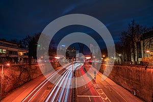 Munich, Germany - fast driving cars next to the central Effnerplatz in the bavarian capital at night with busy traffic