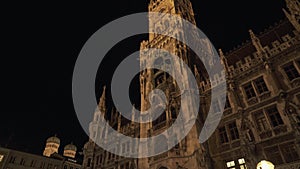 MUNICH, GERMANY - November 26, 2019: Night view of New Town Hall on Marienplatz in Munich. Tilt up real time medium shot