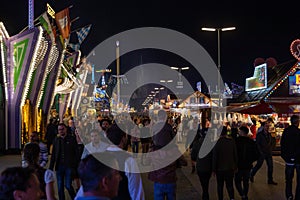 Munich, Germany - September 24: a father is carrying his young son on his shoulders on the oktoberfest in munich at night