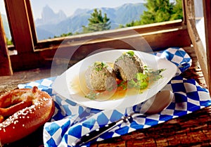 Munich Liver Dumplings with a savory sauce and fresh herbs