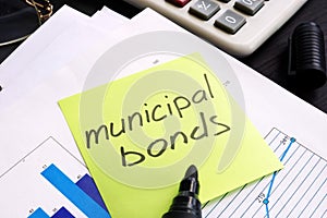 Municipal bond written on a memo stick and documents photo