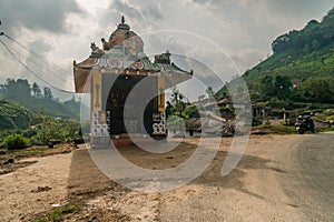 Munnar tea plantation cloudy sky indu temple with his shadow on the path