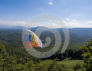 Muntain landscape on the background of Russian flag.