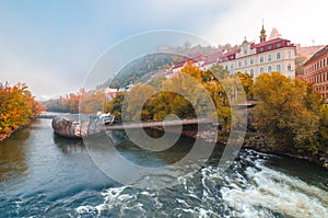 Mur river in autumn, with Murinsel bridge and old buildings in the city center of Graz, Styria region, Austria