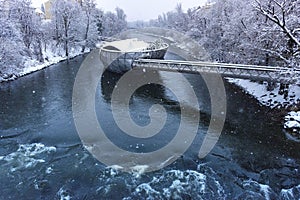 Mur river with Murinsel bridge in Graz, Steiermark region, Austria, with snow, in winter