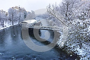 Mur river with Murinsel bridge in Graz, Steiermark region, Austria, with snow, in winter