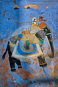 Mural of Maharajah on elephant on blue house wall in Jodhpur