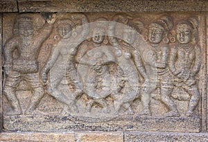 Mural sculpture of group dancing women.