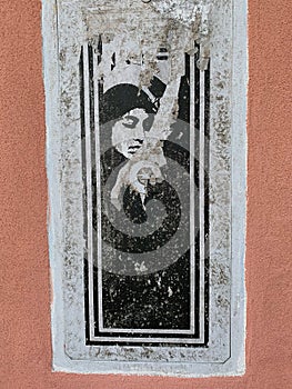 Mural by an unknown author along the street in Giudecca island, Venice, Italy