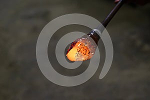 Murano glass manual production at Murano glass-blowing factory. Glassmaker working with molten glass making new piece of