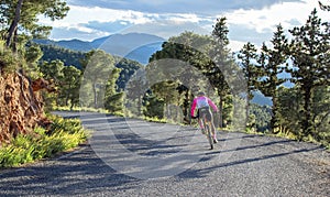 Murcia, Spain - April 9, 2019: Pro road cyclists enduring a difficult mountain ascent on his cool bicycle