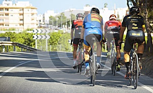 Murcia, Spain - October 9, 2019: Pro road cyclists enduring a difficult mountain ascent on his cool bicycle. Ascend of a